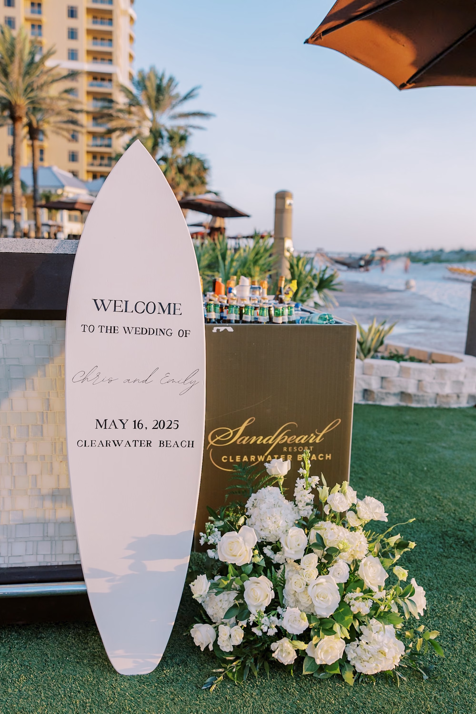 Surfboard Wedding Welcome Sign with White Rose Arrangement at Beachfront Resort Entrance Ideas | Clearwater Beach Planner Special Moments Event Planning