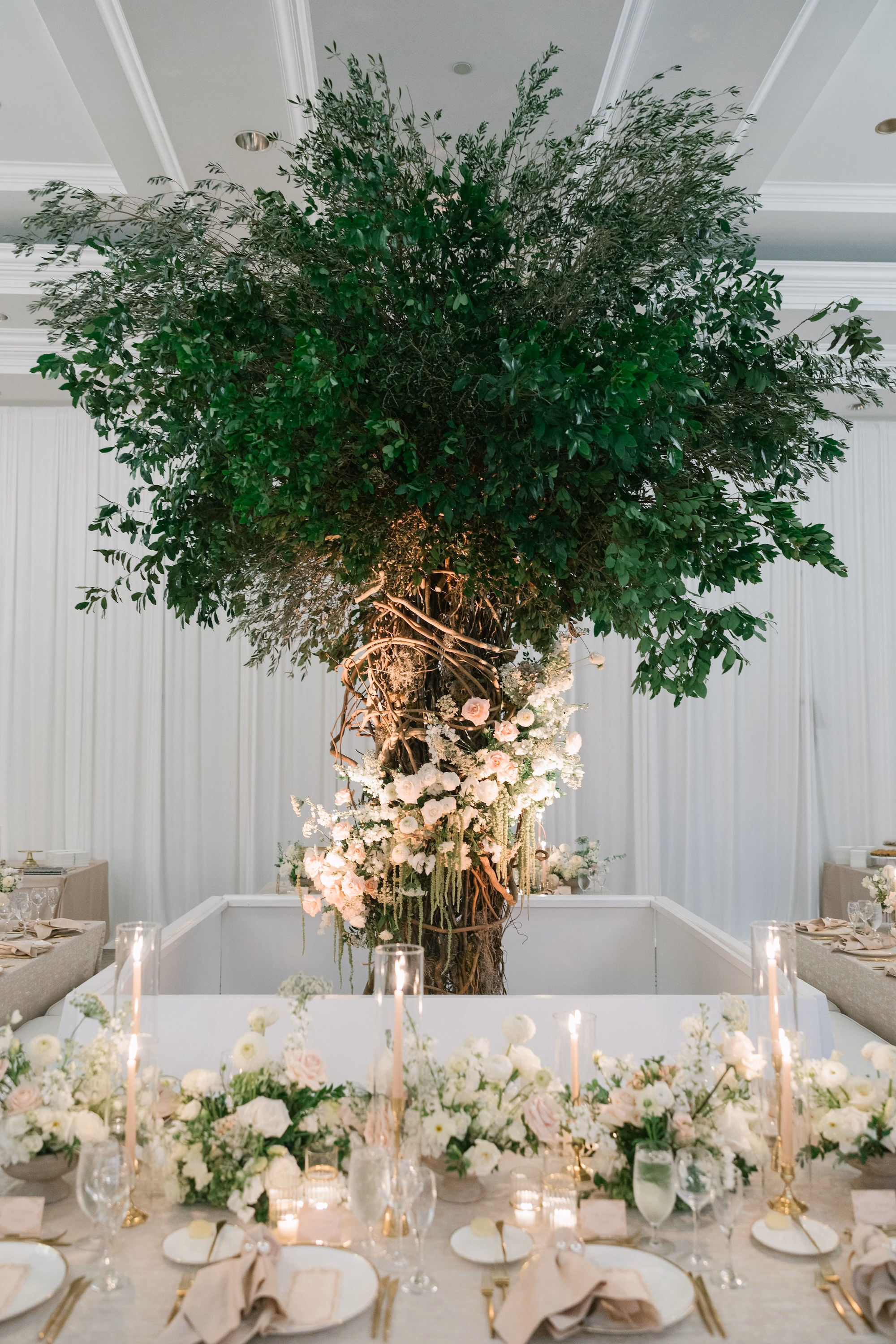 28Luxurious Romantic Garden Ballroom Wedding Inspiration - Luxurious Garden-Inspired Naples Wedding | Hyatt Regency Coconut Point Wedding Reception Head Table with Suspended Greenery Tree Centerpiece | Dramatic Oversized Tree Installation Decor Inspiration | White and Blush Low Floral Runner Ideas | Bonita Springs Venue Hyatt Regency Coconut Point | Planner Parties A’ La Carte