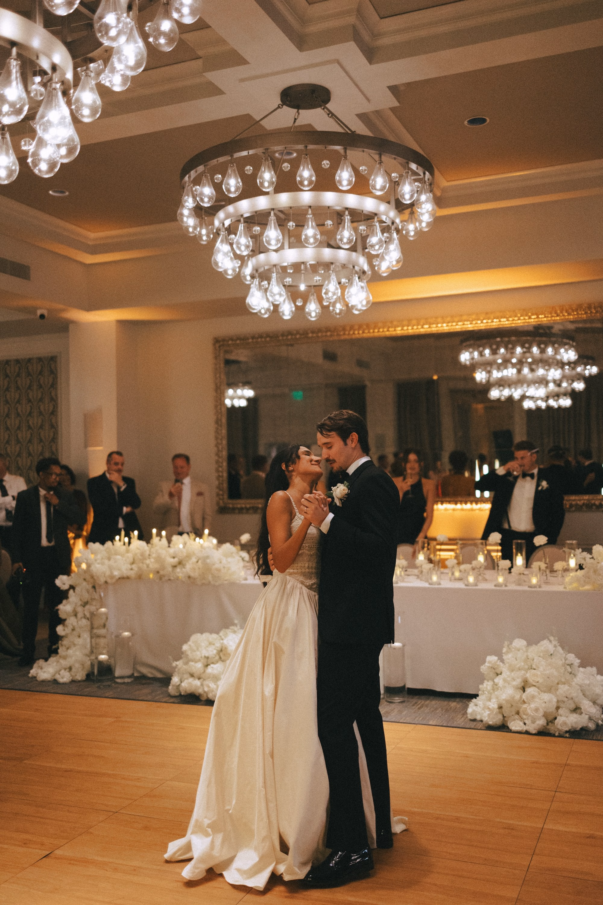 Bride and Groom First Dance Under Crystal Chandelier at Ballroom Wedding Reception | St. Pete Venue The Birchwood