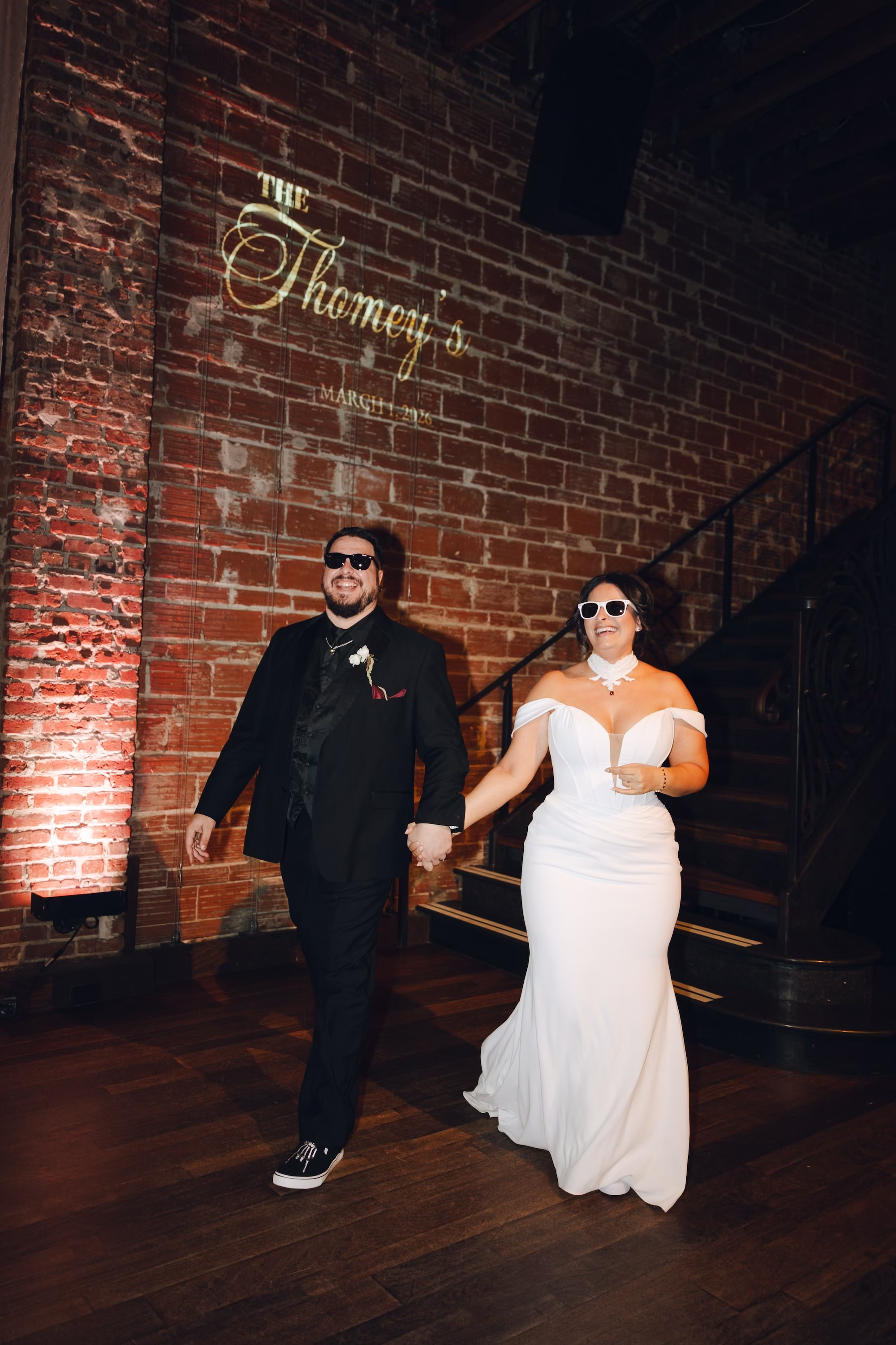 30Burgundy Vintage Romance Wedding Ideas - Vintage Romance Pink and Burgundy Downtown St. Pete Wedding | NOVA 535 Bride and Groom in Sunglasses Grand Entrance with Monogram Projected on Exposed Brick Wall | St. Pete DJ Grant Hemond & Associates