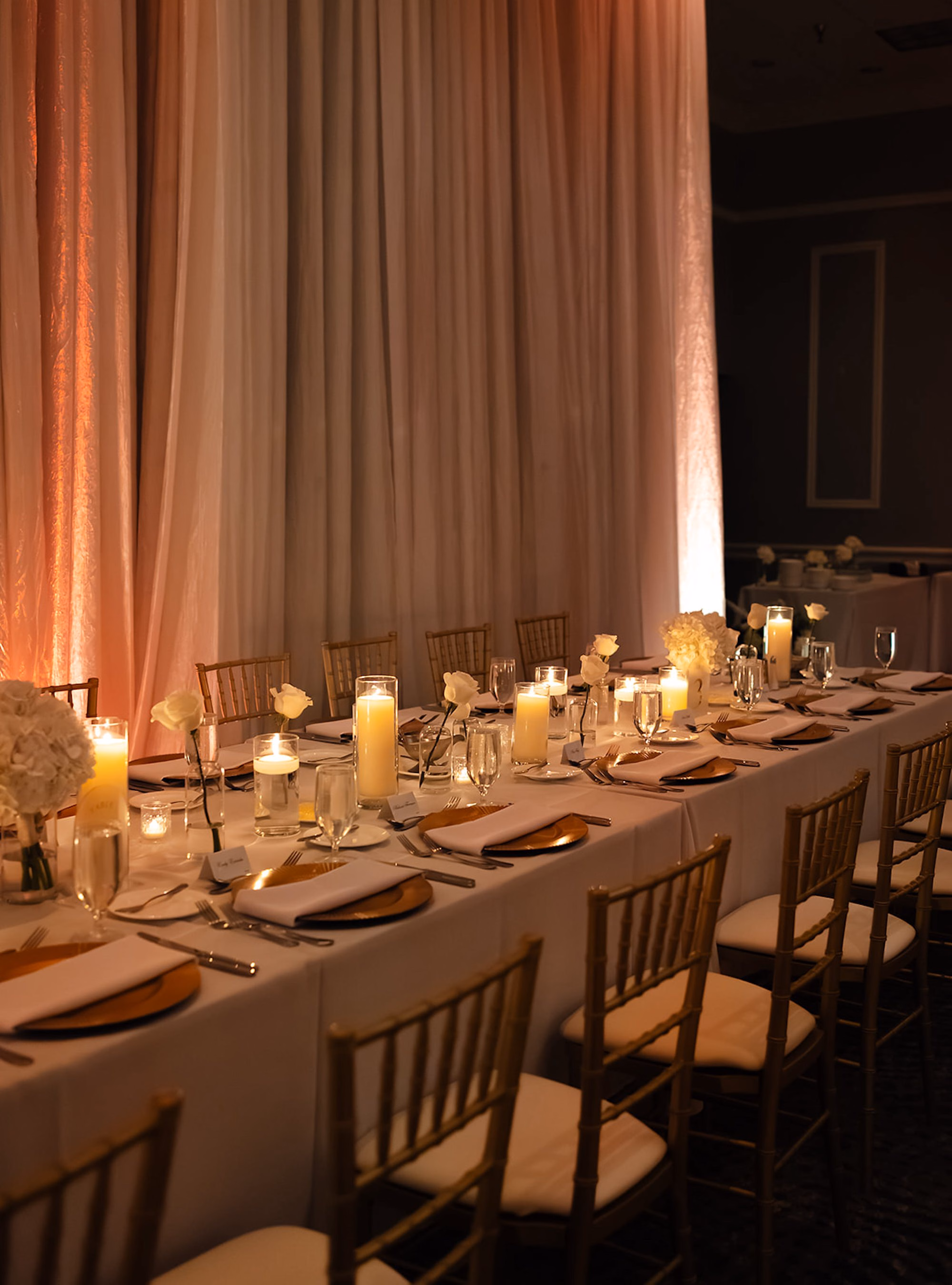 Long Wedding Reception Table with White Linens, Gold Chiavari Chairs, White Rose Bud Vases and Candles Decor Ideas | Palm Harbor Venue Innisbrook Golf & Spa Resort