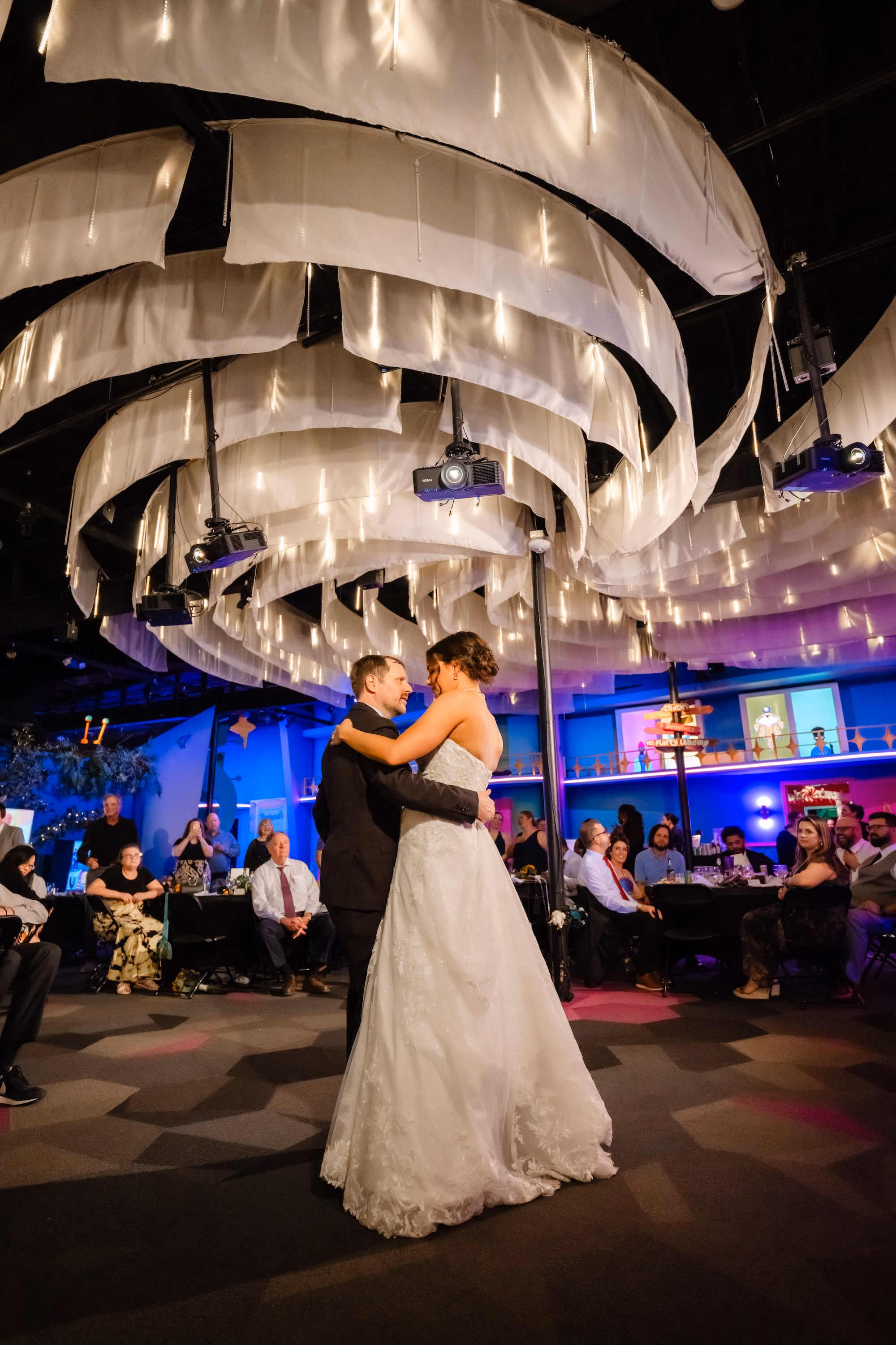 34Vibrant Disco Themed Wedding Inspiration St Pete Musuem Venue FloridaRAMA - Neon Disco Meets Old Florida St. Pete Wedding | FloridaRAMA Bride and Groom First Dance Wedding Portrait | Silver Fringe Ceiling Installation at Immersive Art Museum Wedding Reception St. Pete FloridaRAMA
