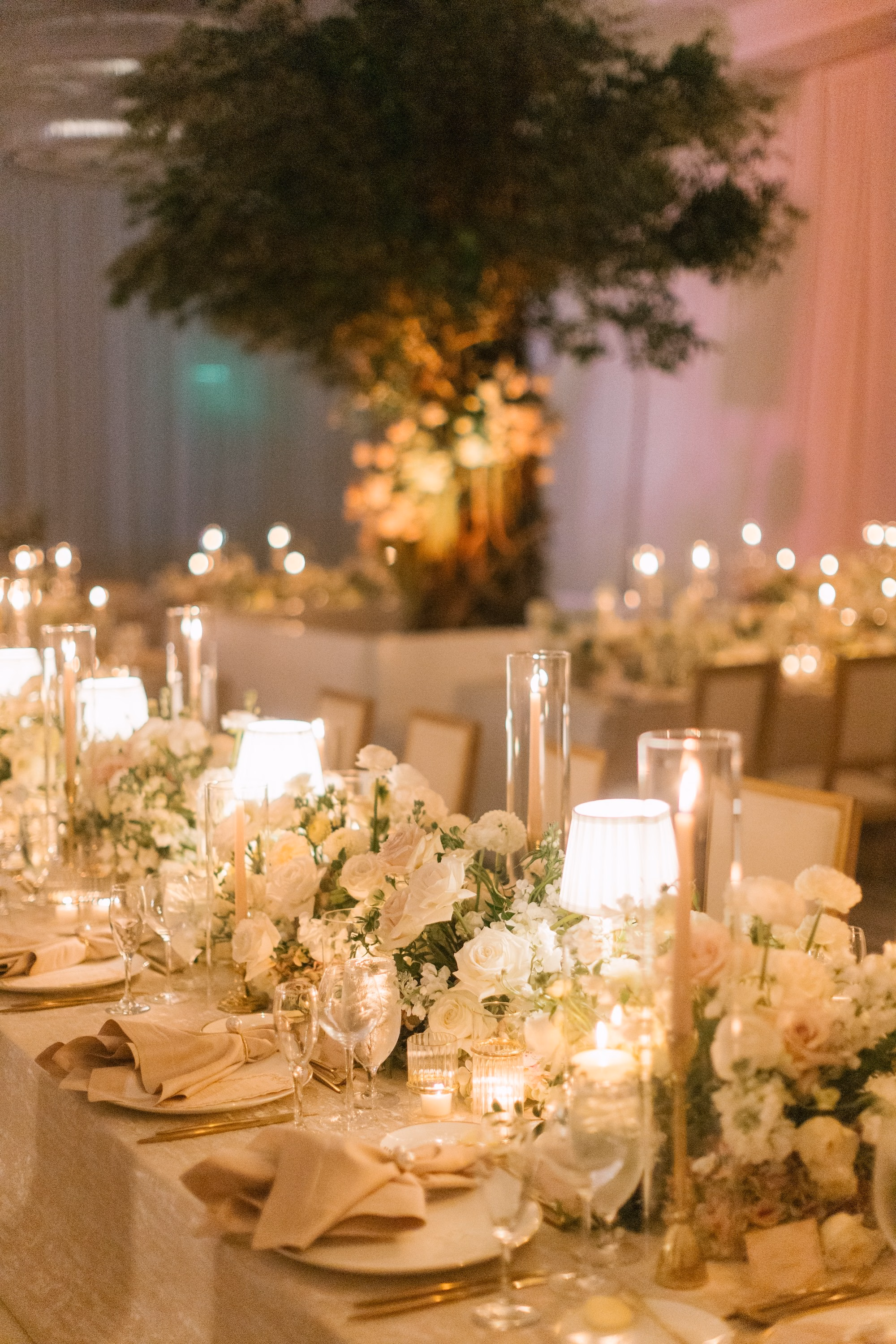35Luxurious Romantic Garden Ballroom Wedding Inspiration - Luxurious Garden-Inspired Naples Wedding | Hyatt Regency Coconut Point Wedding Reception Table with Taper Candles and Greenery Centerpiece | Warm Candlelit Reception Decor Inspiration | Blush Napkin and Gold Flatware Place Setting Ideas | Bonita Springs Venue Hyatt Regency Coconut Point | Planner Parties A’ La Carte
