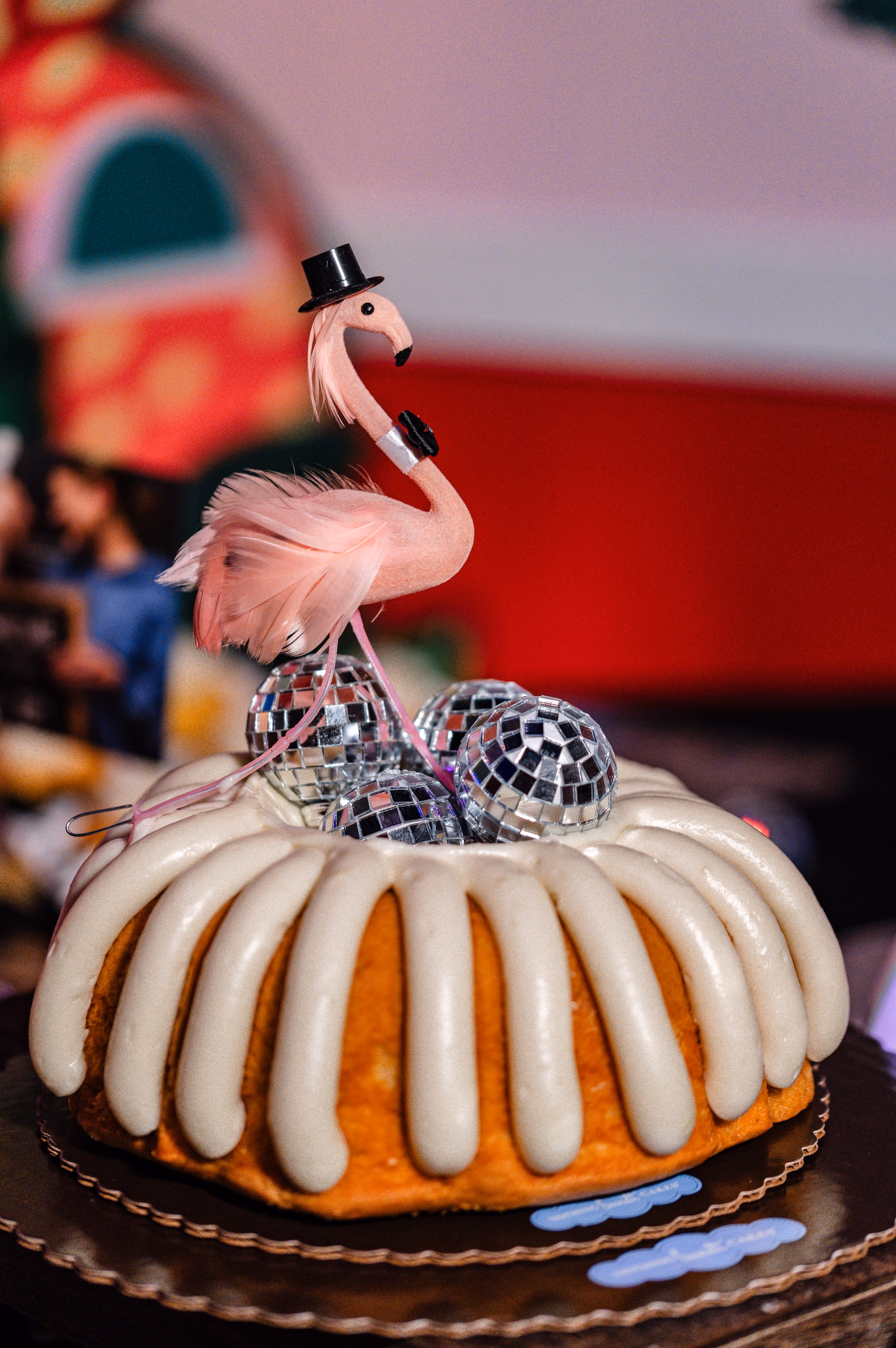 35Vibrant Disco Themed Wedding Inspiration St Pete Musuem Venue FloridaRAMA - Neon Disco Meets Old Florida St. Pete Wedding | FloridaRAMA Mini Bundt Cake Dessert with Disco Balls and Flamingo Cake Topper Wedding Reception Ideas | Disco Ball Wedding Reception Decor Inspiration