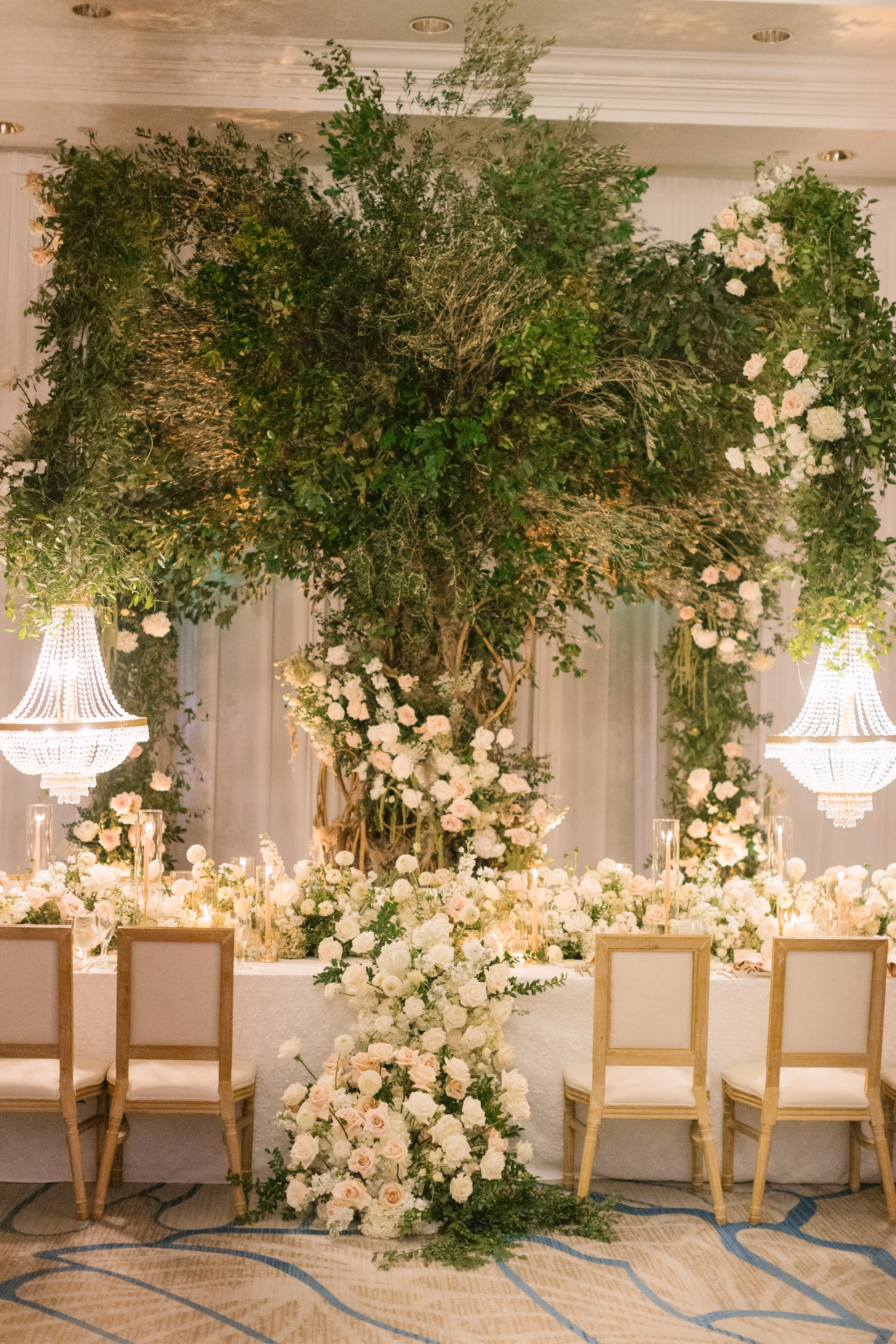 38Luxurious Romantic Garden Ballroom Wedding Inspiration Bonits Springs Venue Hyatt Regency Coconut Point - Luxurious Garden-Inspired Naples Wedding | Hyatt Regency Coconut Point Wedding Reception Head Table with Greenery Tree Installation | Luxury Garden Ballroom Wedding Decor Inspiration | Crystal Chandelier and Gold Chair Ideas | Bonita Springs Venue Hyatt Regency Coconut Point | Planner Parties A’ La Carte