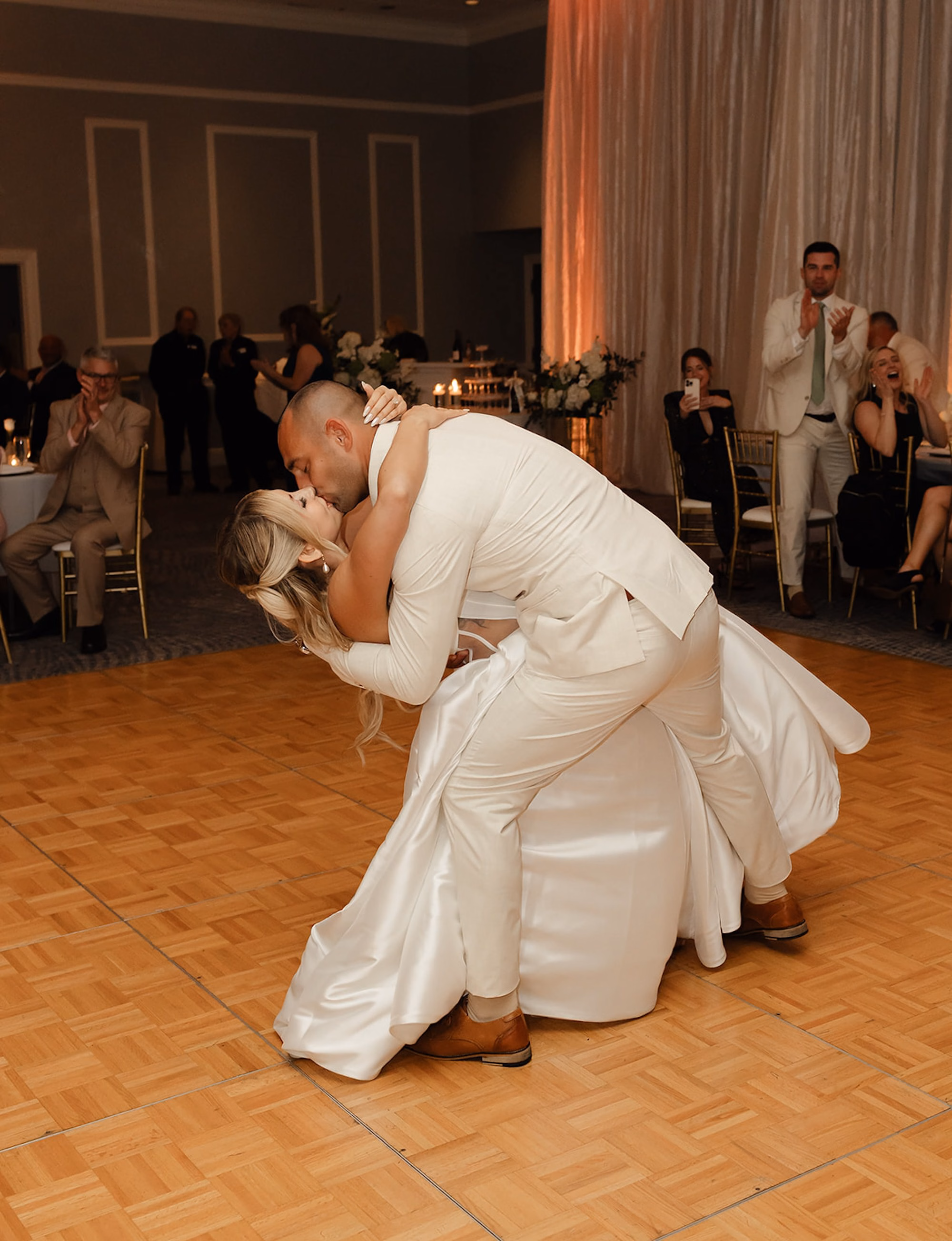 Groom Dipping Bride During First Dance at Ballroom Wedding Reception