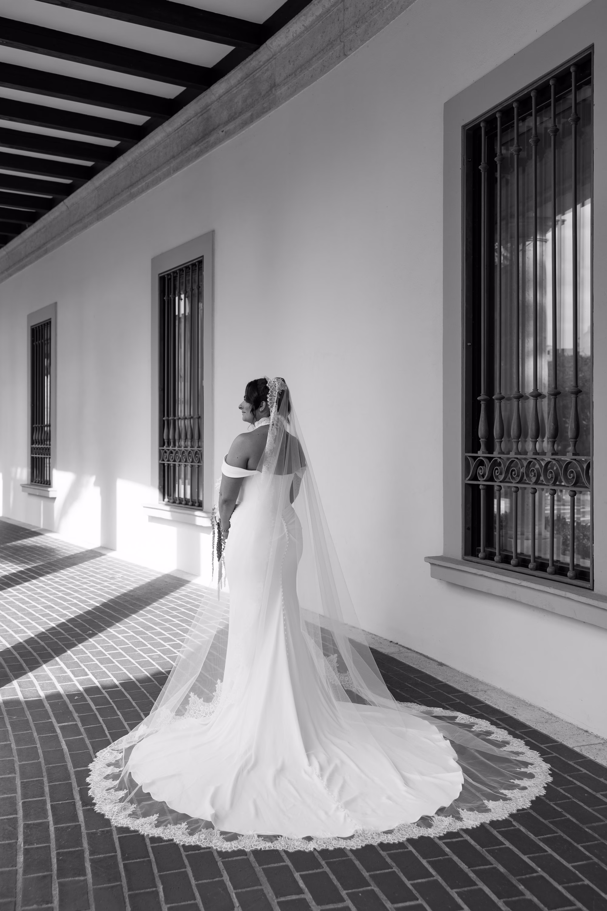 5Burgundy Vintage Romance Wedding Ideas - Vintage Romance Pink and Burgundy Downtown St. Pete Wedding | NOVA 535 Black and White Bridal Portrait of Lace-Trimmed Cathedral Veil and Lace Hem Train in Arched Walkway